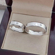 Silver wedding rings with white cubic zirconia in the middle rhodium plated pair