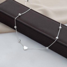 Silver necklace chain with silver beads and a heart in the middle