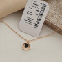 Thin chain gold necklace with heart pendant and black enamel