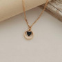 Thin chain gold necklace with heart pendant and black enamel
