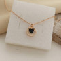Thin chain gold necklace with heart pendant and black enamel