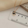 Thin chain gold necklace with heart pendant and black enamel