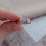 Комплект золотий каблучка та сережки з овальними блакитними топазами 8.97