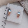 Комплект золотий каблучка та сережки з овальними блакитними топазами 8.97