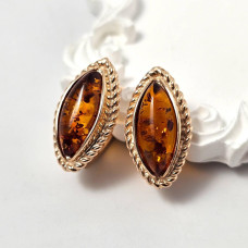 Women's gold earrings with oval amber stone