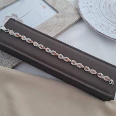 Silver infinity bracelet with gold inserts and round white zircons