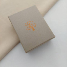 Rectangular box for a ring and earrings with a beige ornament