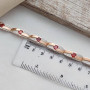 Браслет срібний із золотими напайками білими цирконами та червоним гранатом